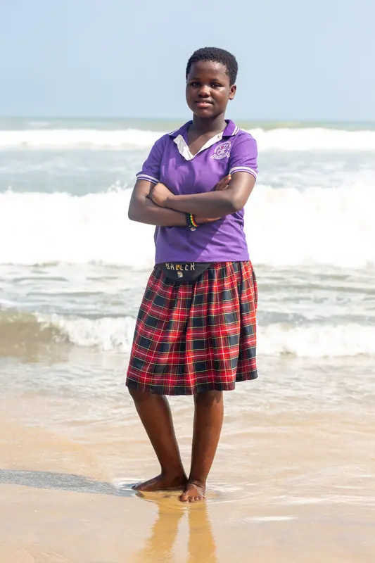 A pupil in school polo at the shoreline