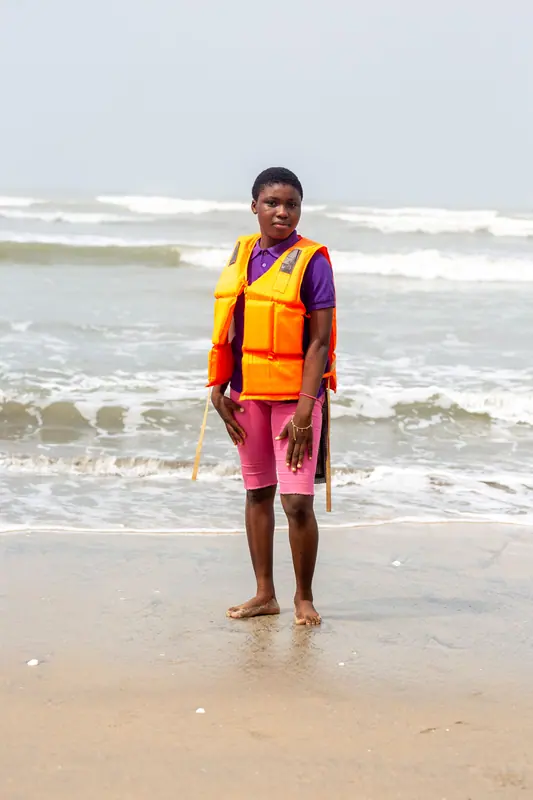 A pupil in a life jacket on the beach