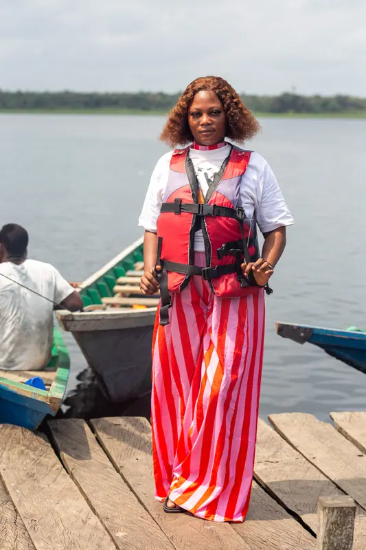 A member of staff on the jetty beside a canoe