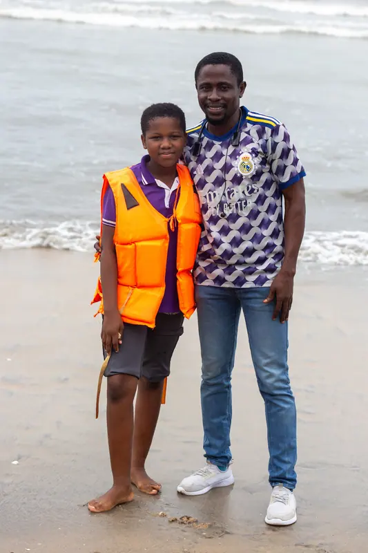 A pupil and an older student together on the beach