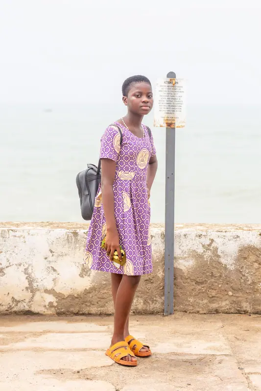 A pupil on the castle ramparts beside a lamp post