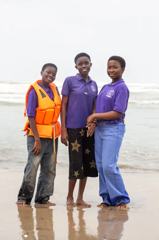 Three pupils together at the water's edge