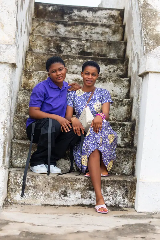 Two pupils seated on the castle stairway