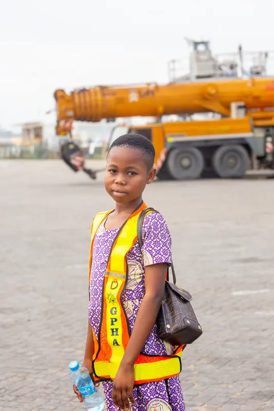 A pupil in a high-visibility vest at the harbour