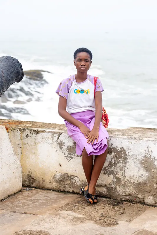 A pupil seated on the castle sea wall