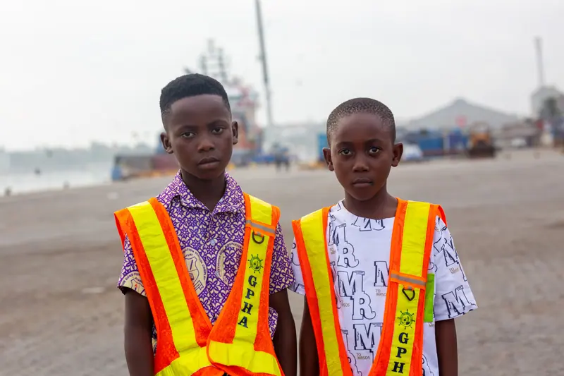 Two pupils in high-visibility vests at the harbour