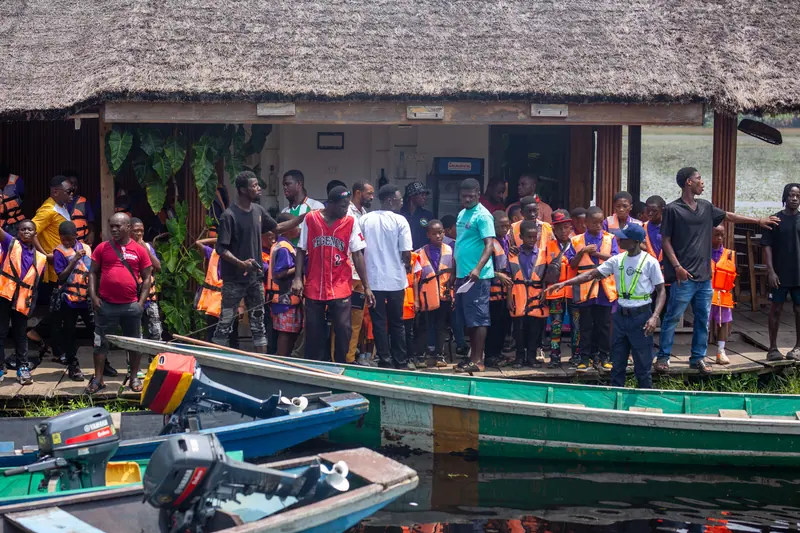 Pupils in life jackets boarding the canoes at the jetty