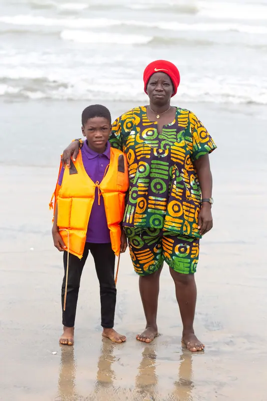 A pupil and a member of staff on the beach