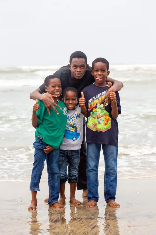 A member of staff with young pupils on the beach