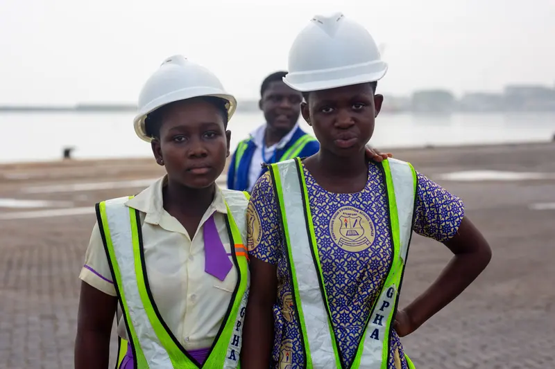 Two pupils in safety helmets at the harbour