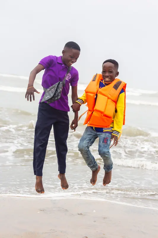 Two pupils jumping in the surf