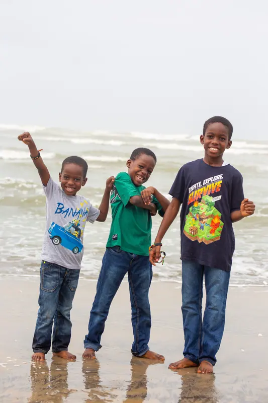 Three young pupils on the beach
