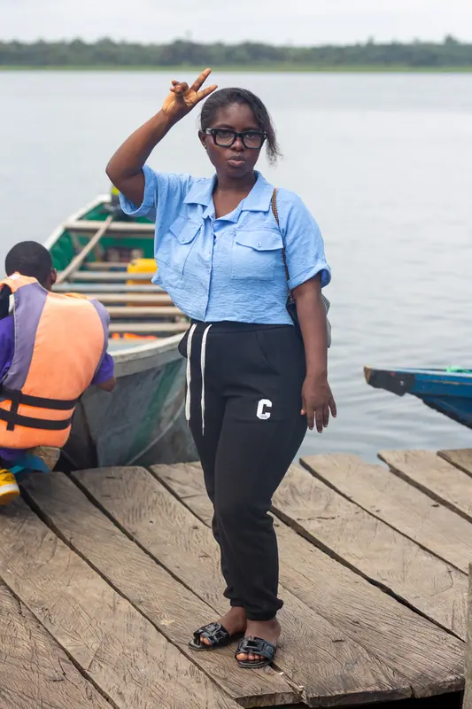 A member of staff on the jetty beside a canoe