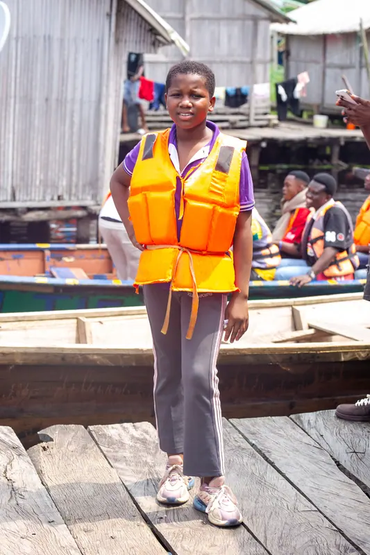 A pupil in a life jacket on the village jetty