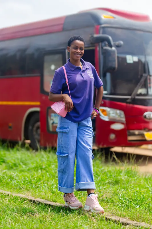 A member of staff beside the coach